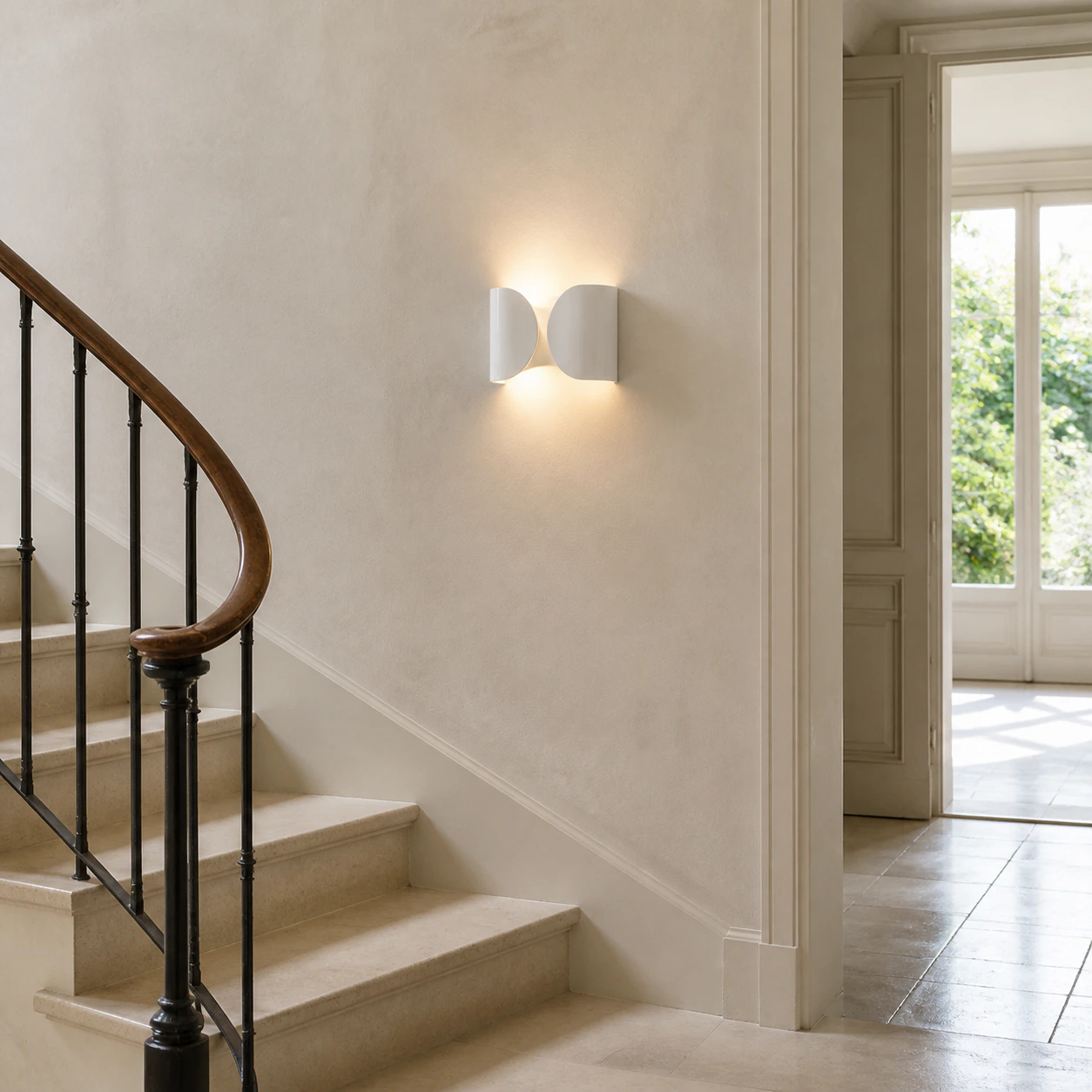 White Foglio Wall Lamp illuminating a bright stair landing