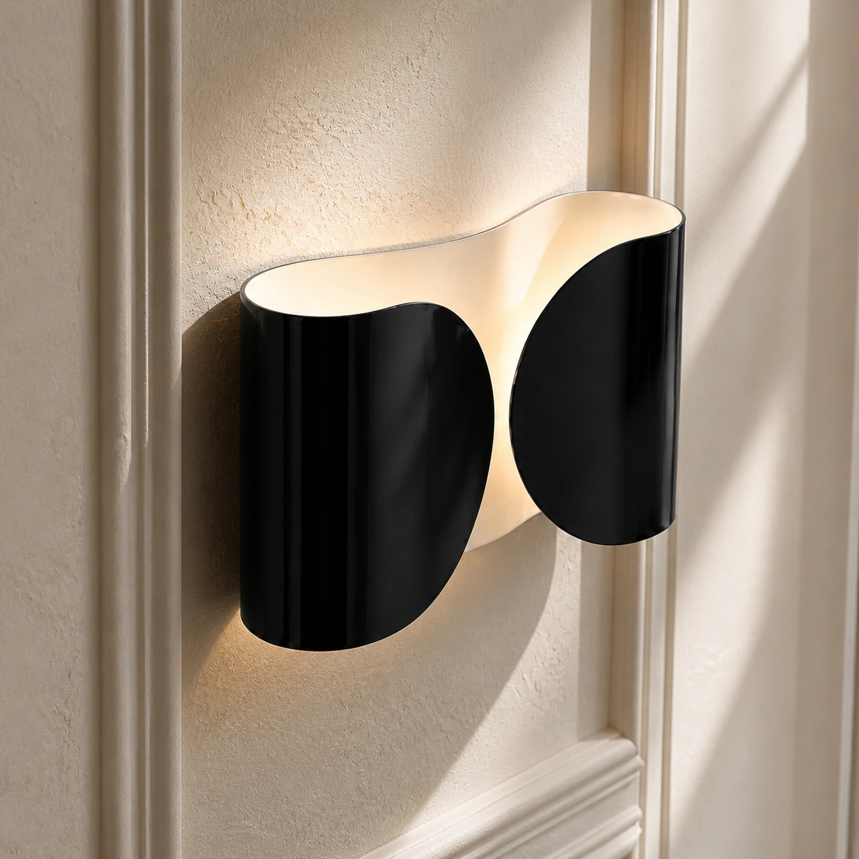 Close view of the Black Foglio Wall Lamp's formed steel curves