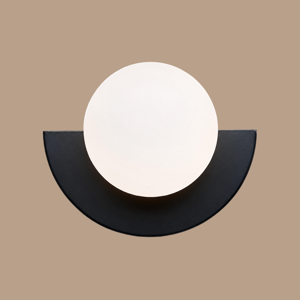 Black Macaron orb wall lamp on light brown background