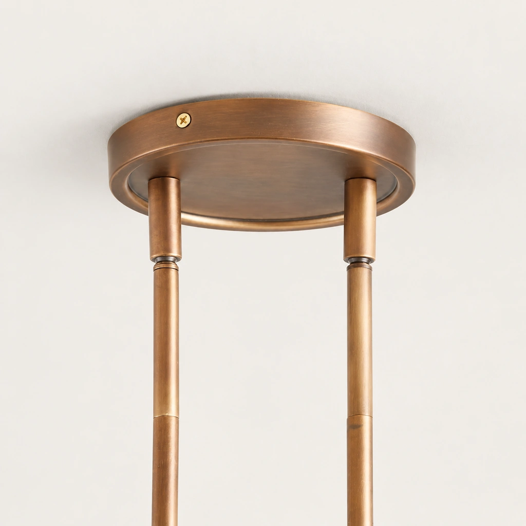Close-up of Zane round brass ceiling canopy, side screw, and two sleeved suspension rods