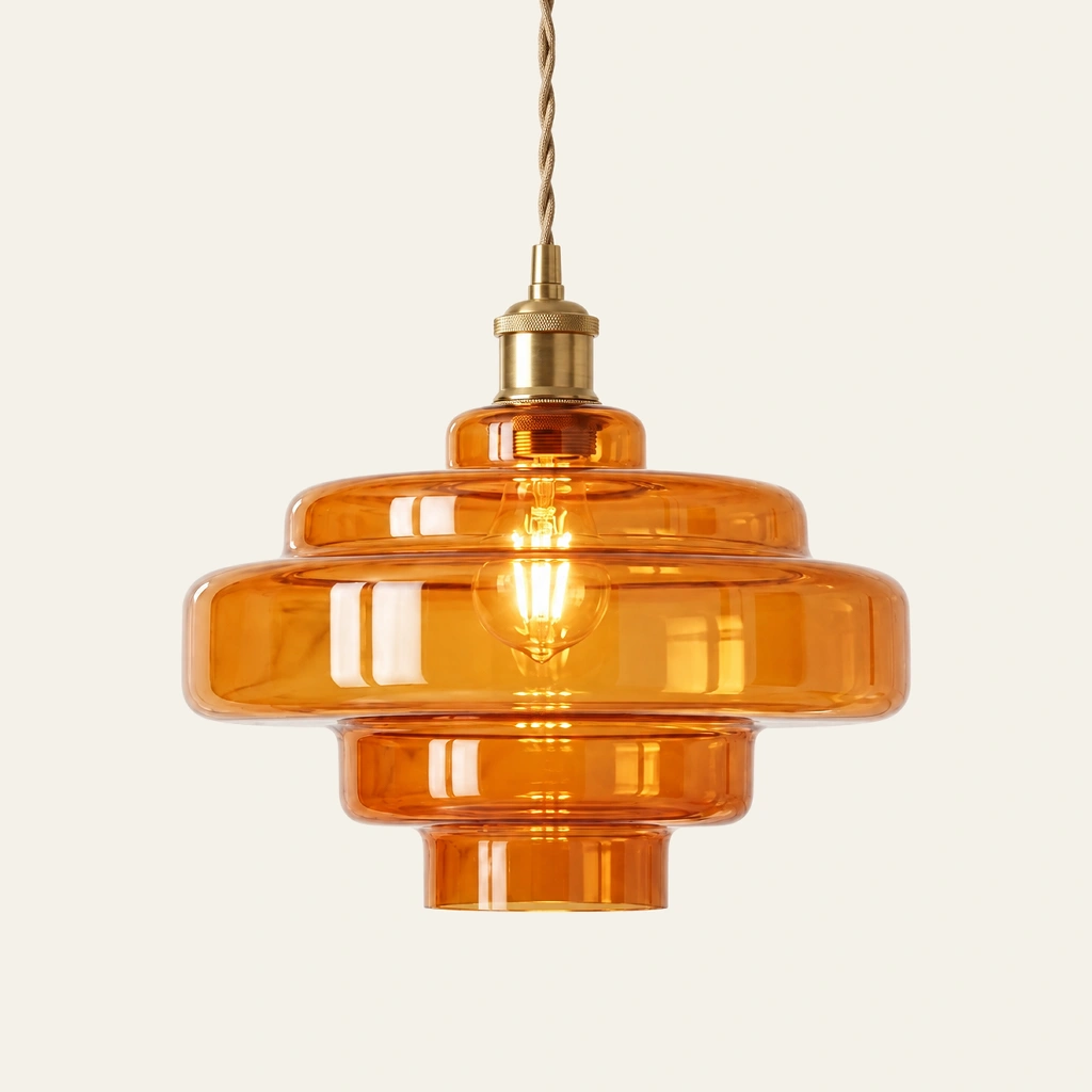 Mirelle pendant light in Amber Orange, metal connector, on an ivory background