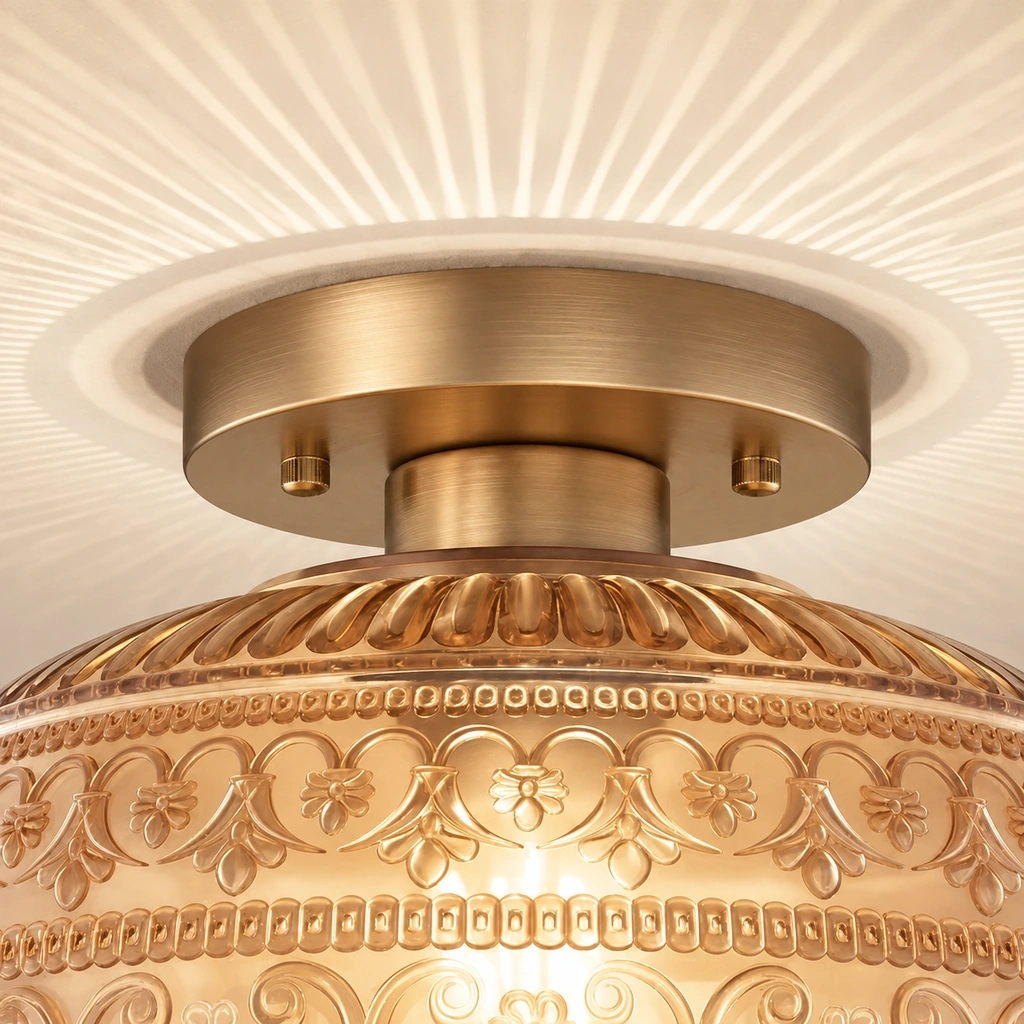 Close view of the Oliver metal canopy mount and upper relief band of the amber glass shade