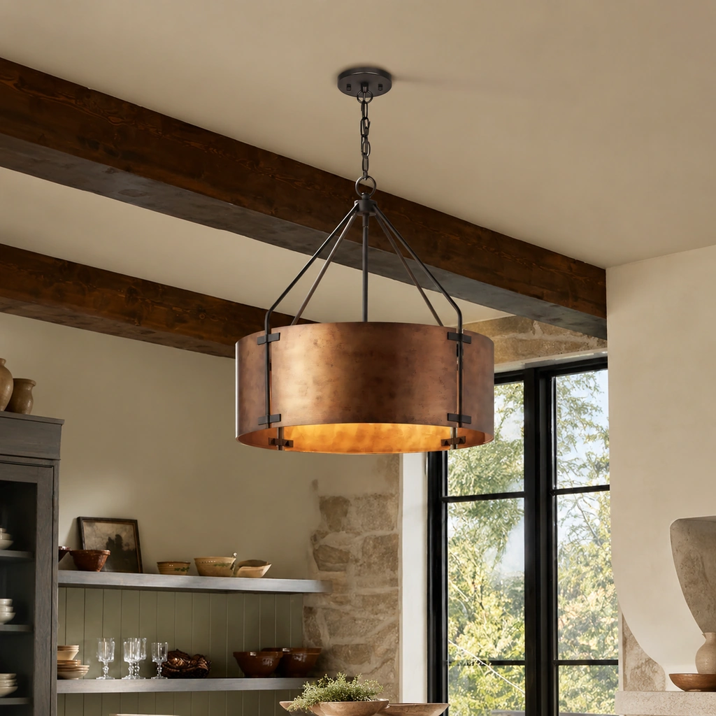 Ronan drum pendant with round ceiling canopy, chain suspension, and dark triangular support rods above an aged metal drum shade, hung from a wood-beamed ceiling