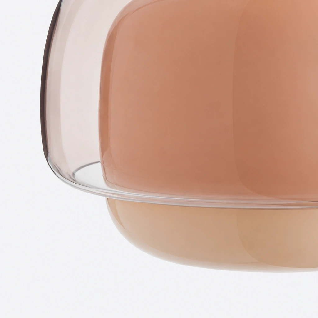 Closer view of the lower shade edge: the pink inner diffuser meets the outer glass along the lower boundary, shown unlit