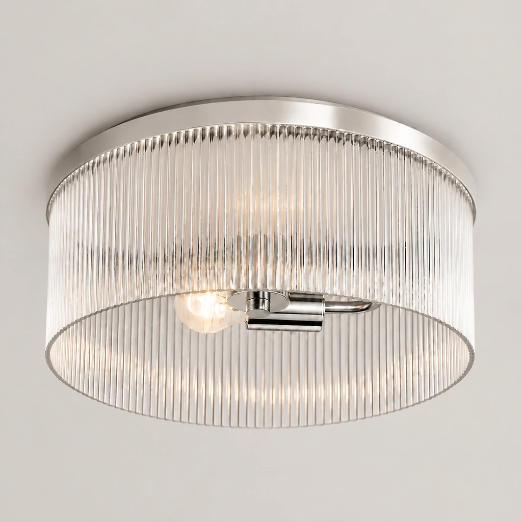 Polished Nickel Vesper flush mount with ribbed glass drum on a plain background
