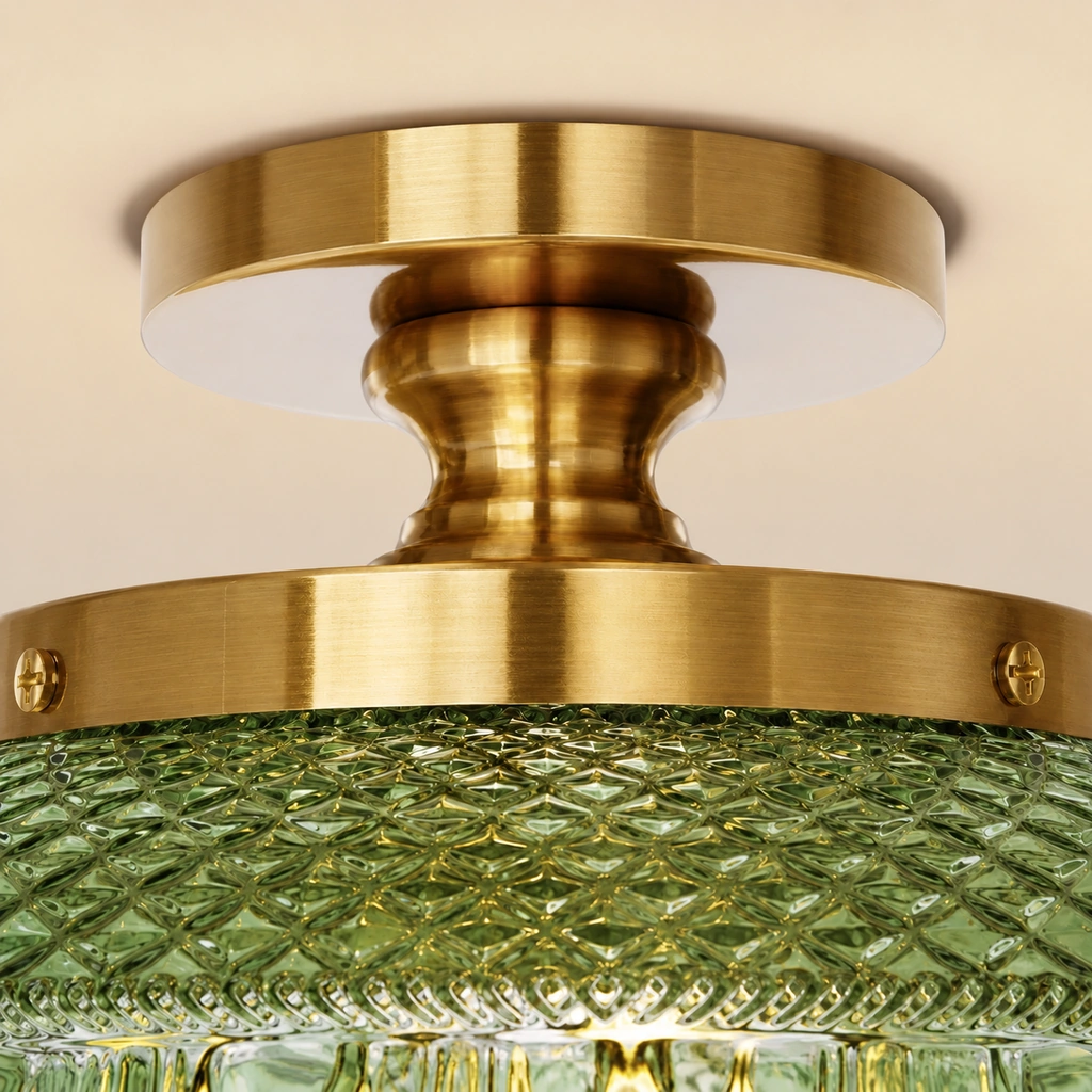 Close-up of Jules gold metal canopy and stem above green patterned glass