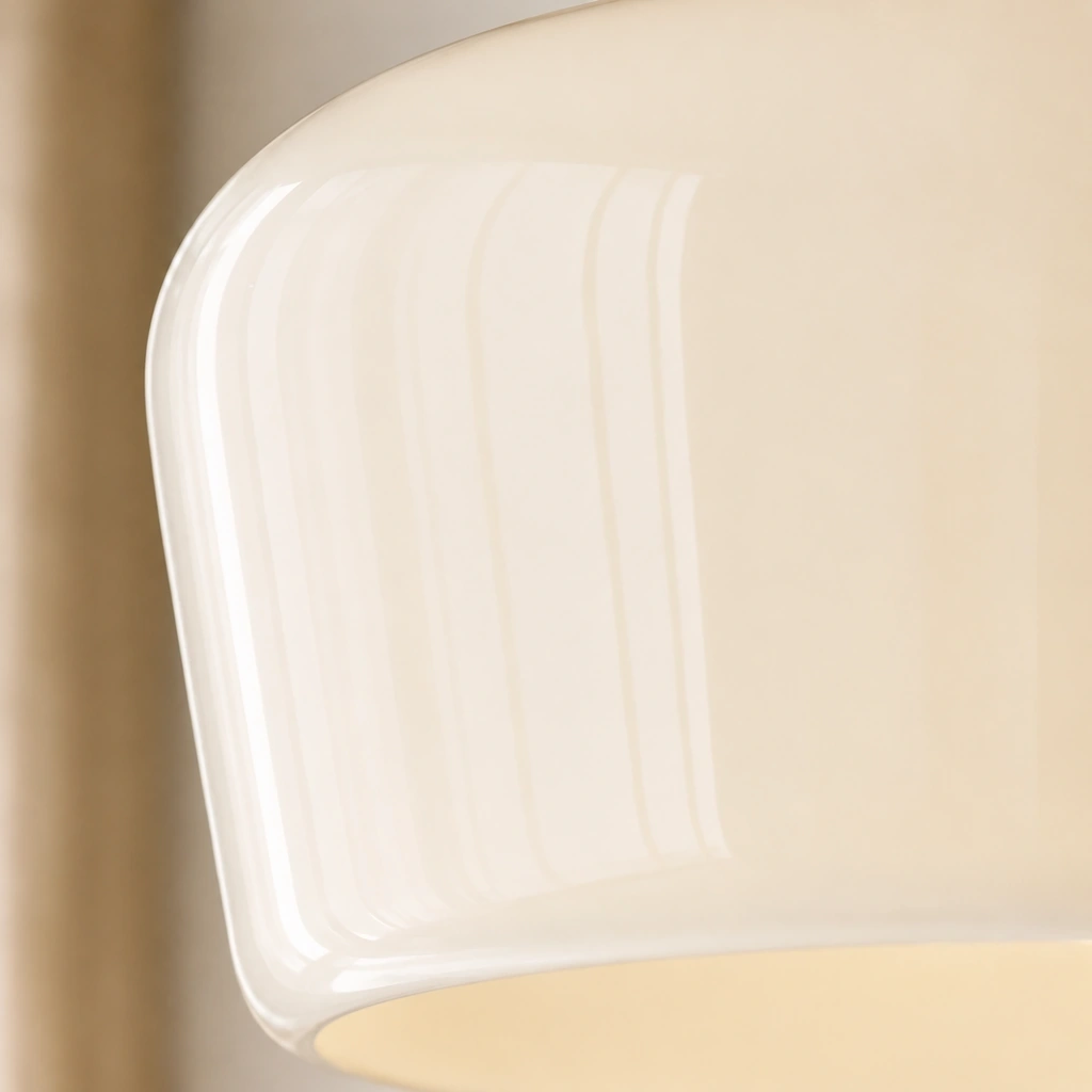 Close view of the Aster milk-glass shade edge and glossy surface