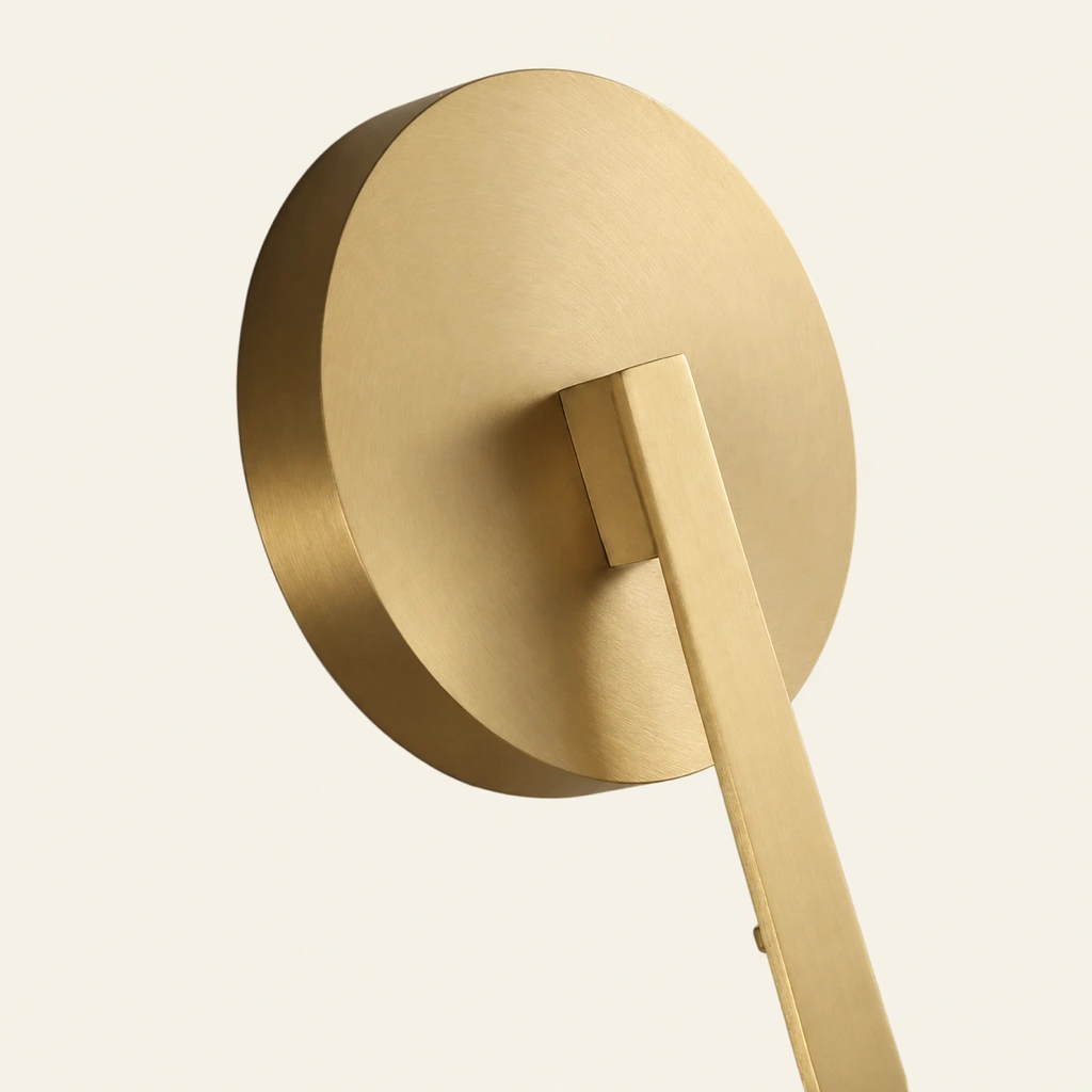 Brass circular wall plate and arm detail