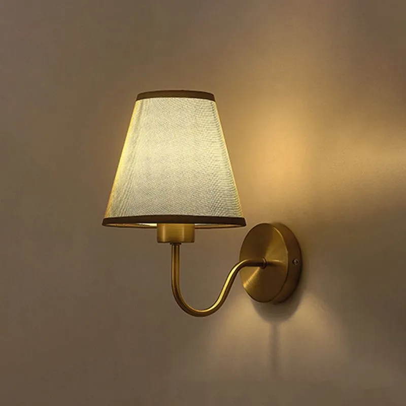 Dark fabric Eryn wall sconce illuminated on a wall
