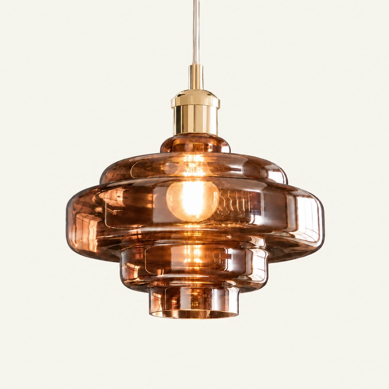 Mirelle pendant light in Brown, metal connector, on an ivory background