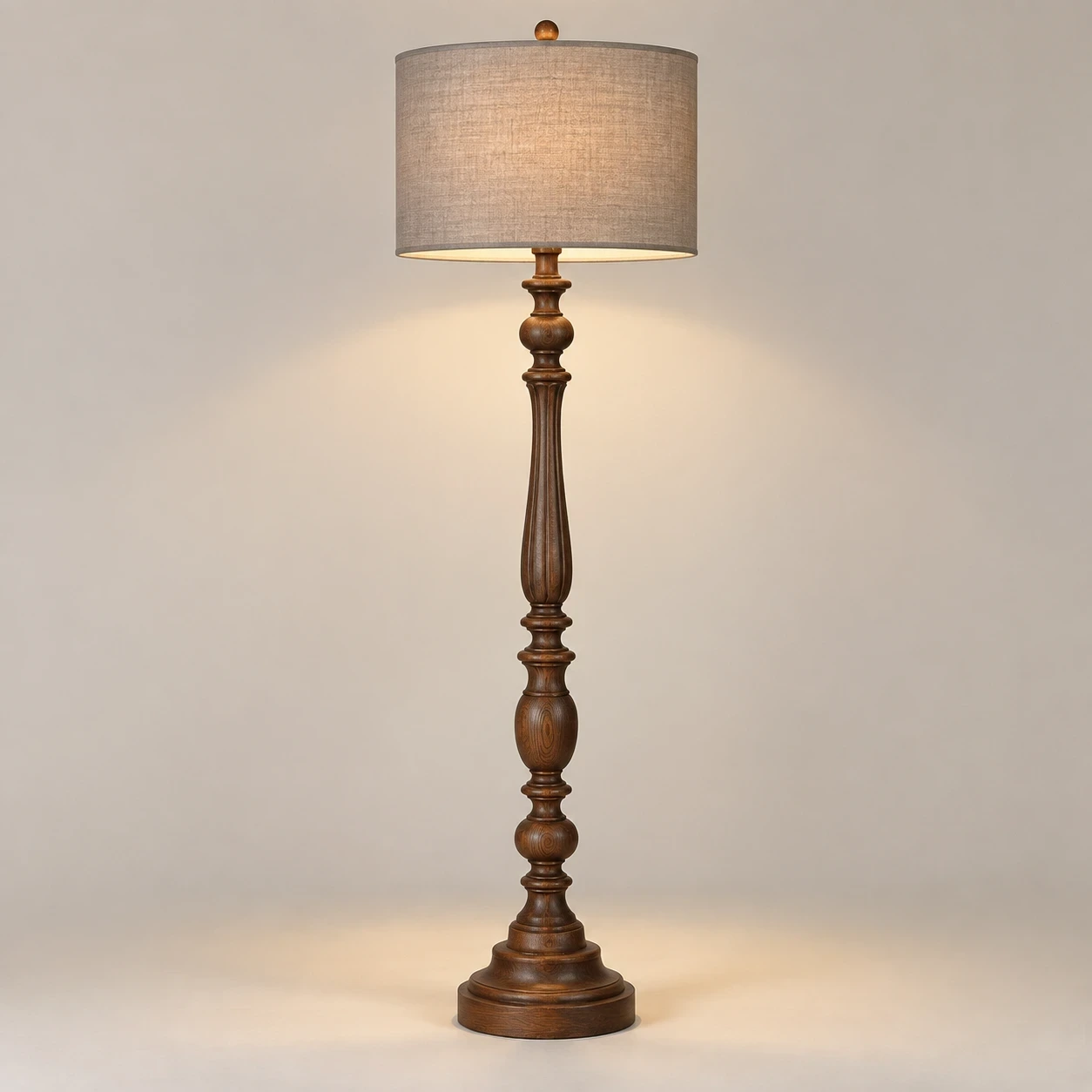Merritt carved wood floor lamp illuminated in a neutral studio
