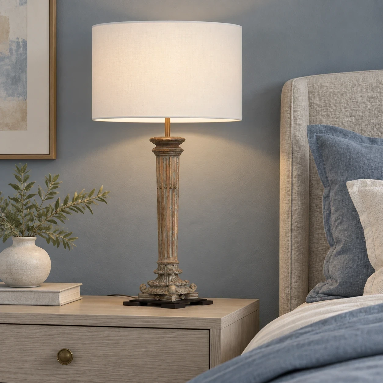 Aveline table lamp beside blue-gray linen in a bedroom setting