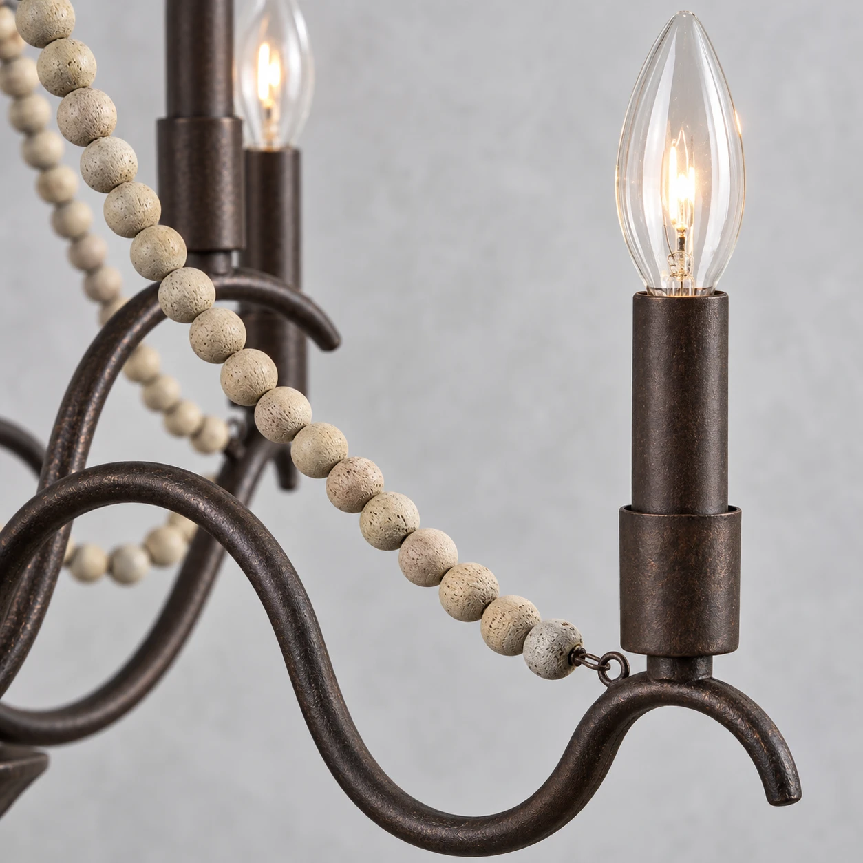 Close detail of matte iron branches and natural wood beads