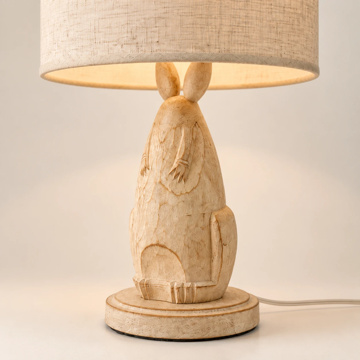 Close detail of the carved rabbit wood body and rounded base