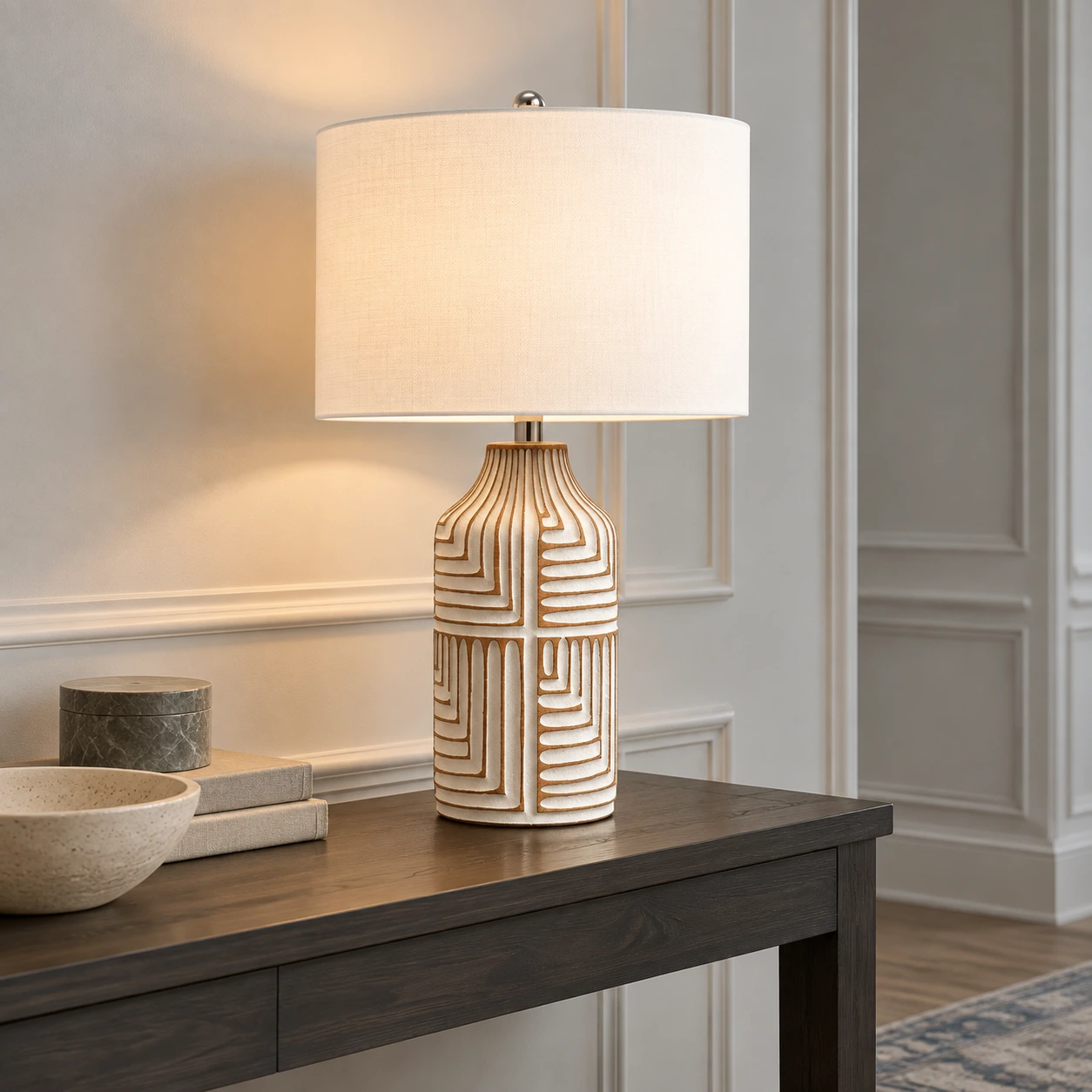 Odette table lamp on a charcoal console in a pale gray paneled entry