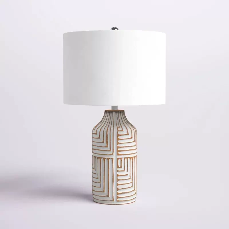 Odette carved wood table lamp on a light neutral background