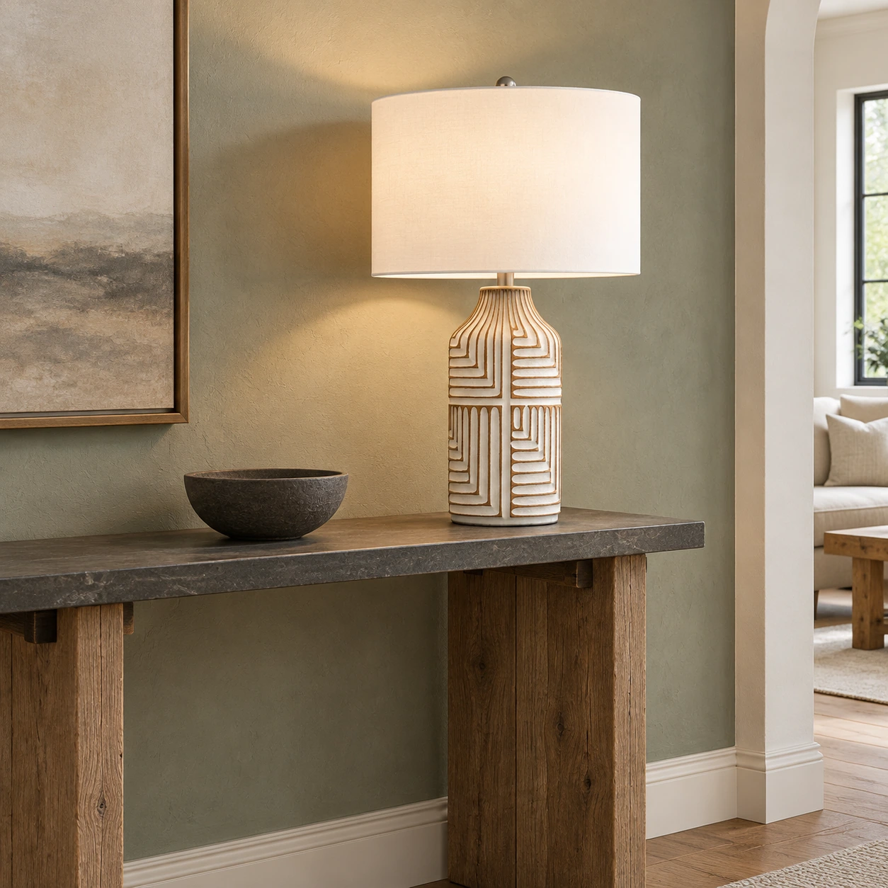 Odette table lamp on a reclaimed-oak console against muted sage plaster