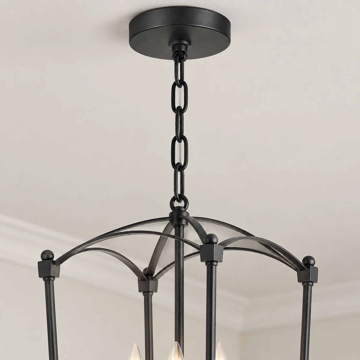 Close view of the Mabel chandelier's round canopy and short hanging chain