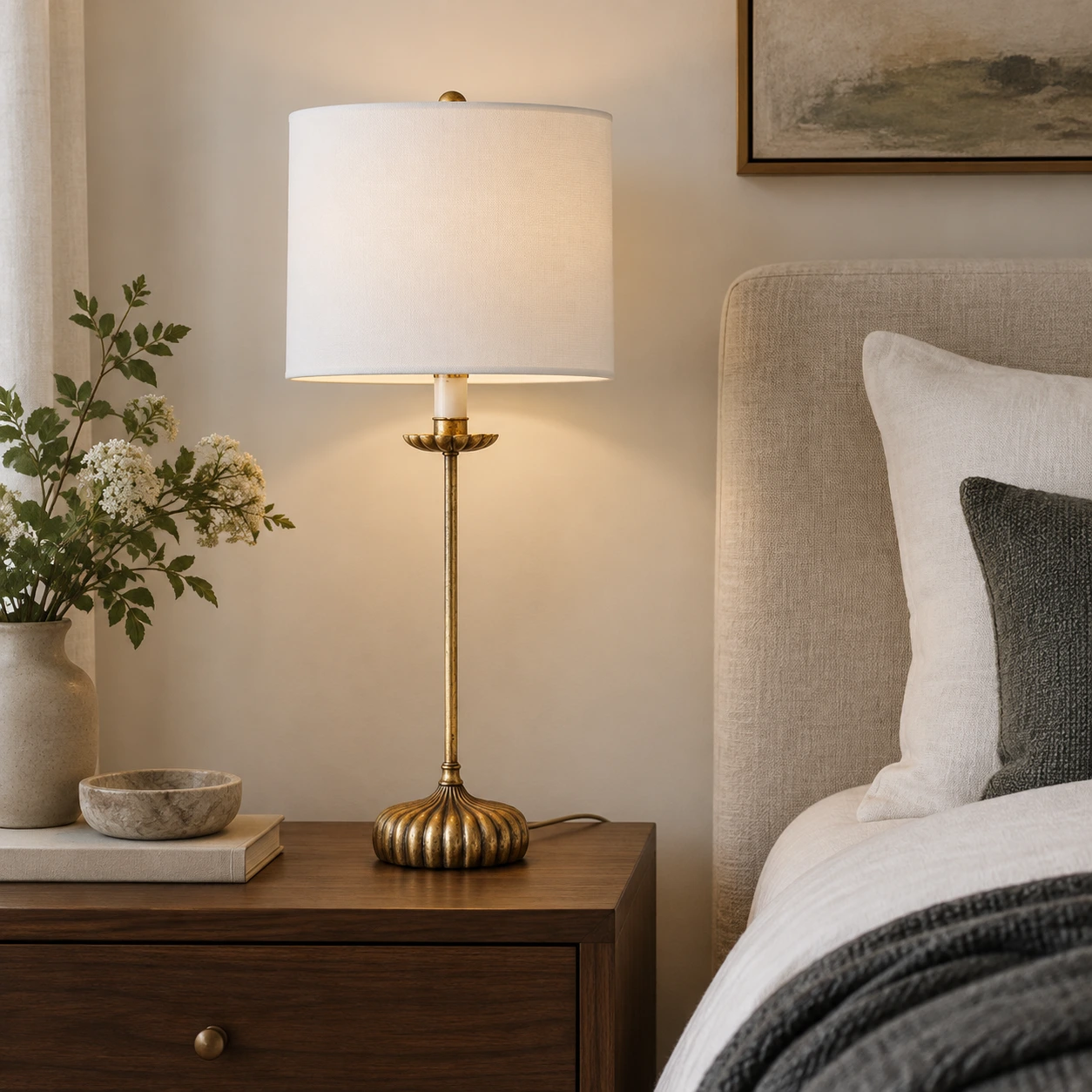 Distressed iron table lamp on a bedroom nightstand