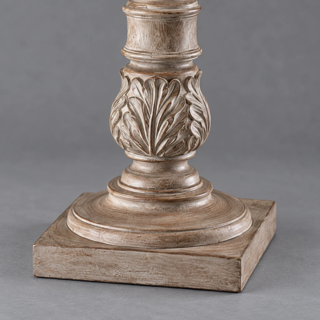 Close detail of the stepped base and carved acanthus-leaf woodwork