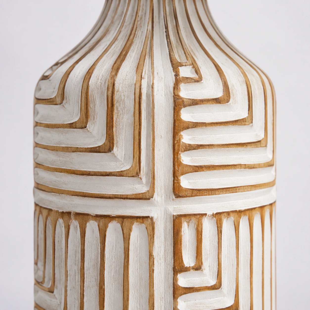 Close detail of the Odette lamp carved white wood relief and warm tan grooves