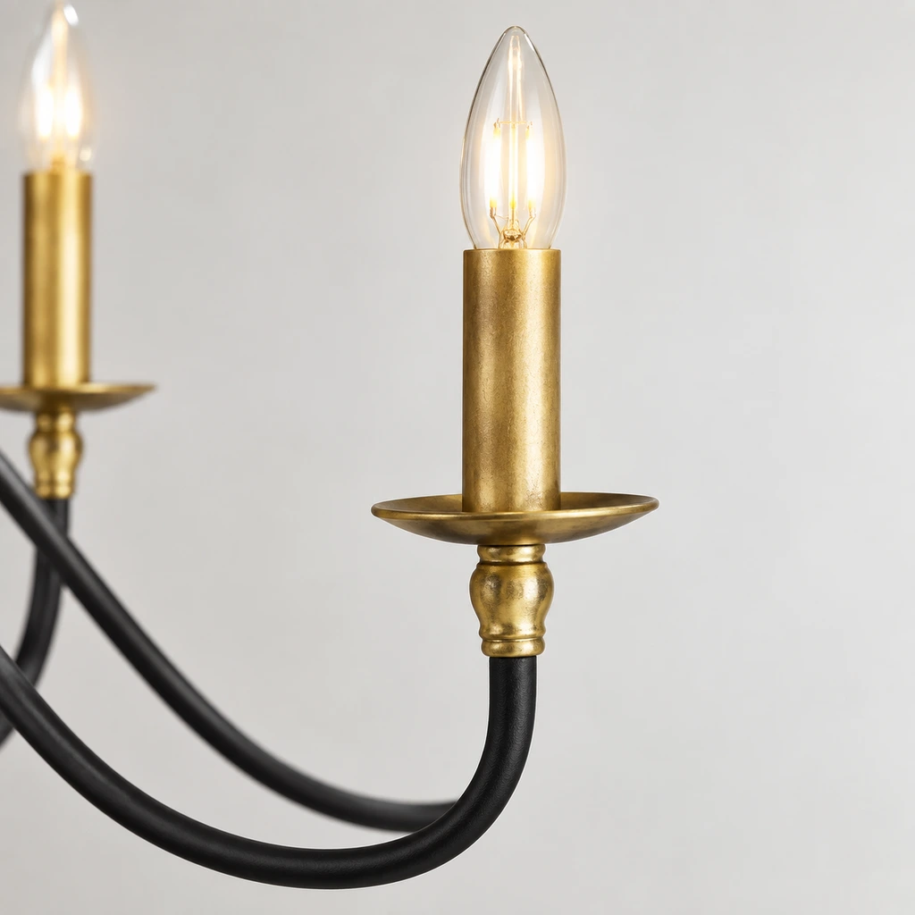 Close view of an Arden vintage-gold candle socket and black iron arm