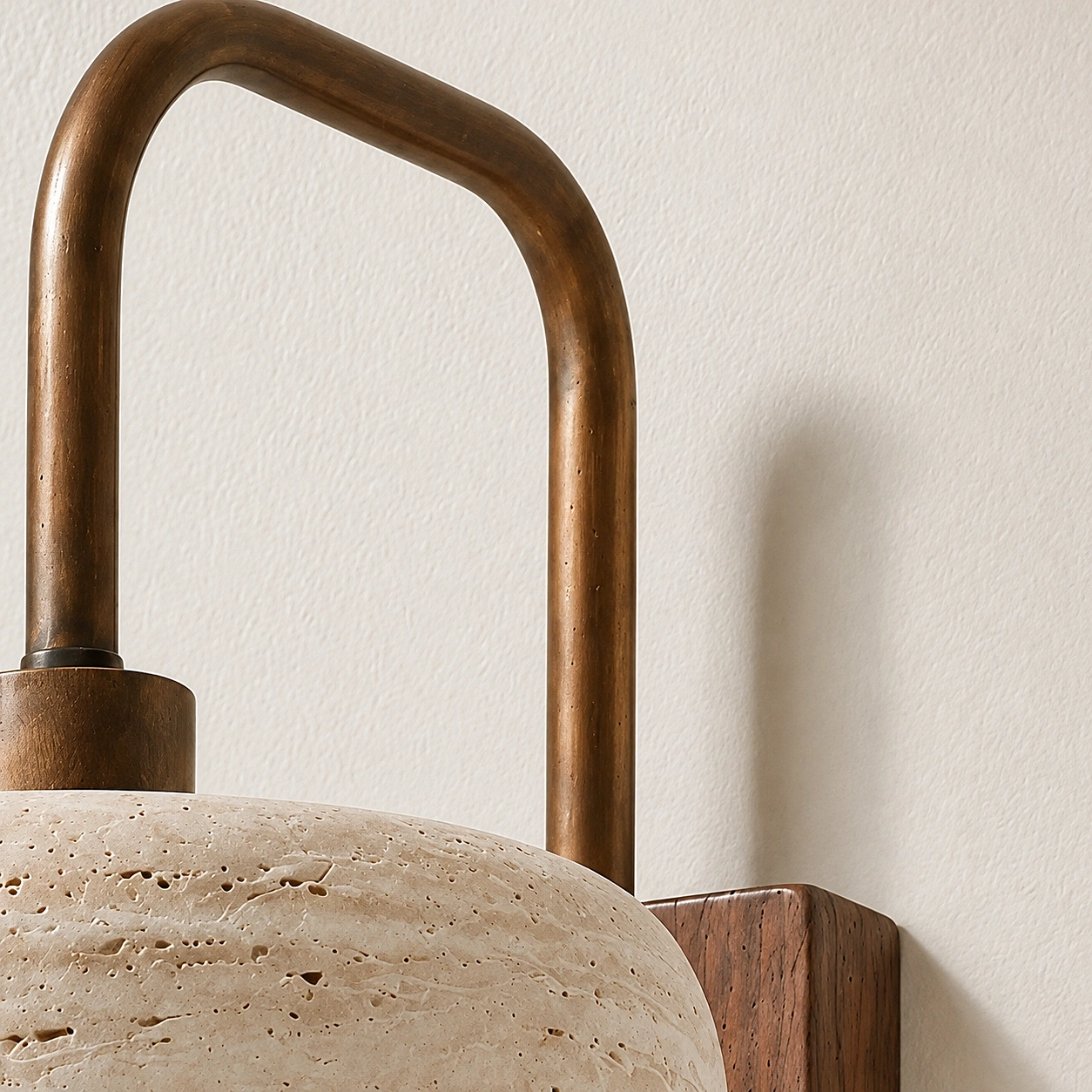 Close detail of arched support on Maelle wall lamp