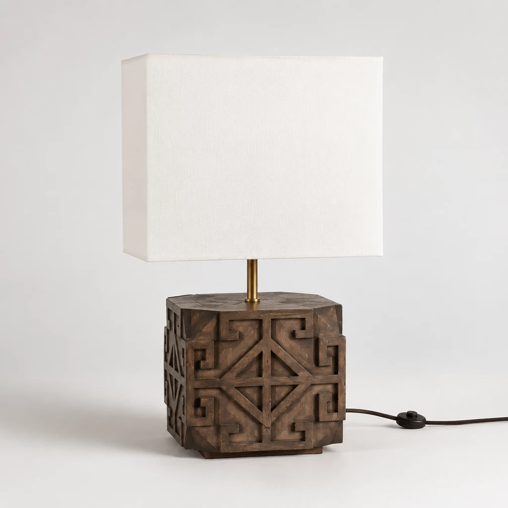 Aurelia carved wood table lamp switched off in a neutral studio