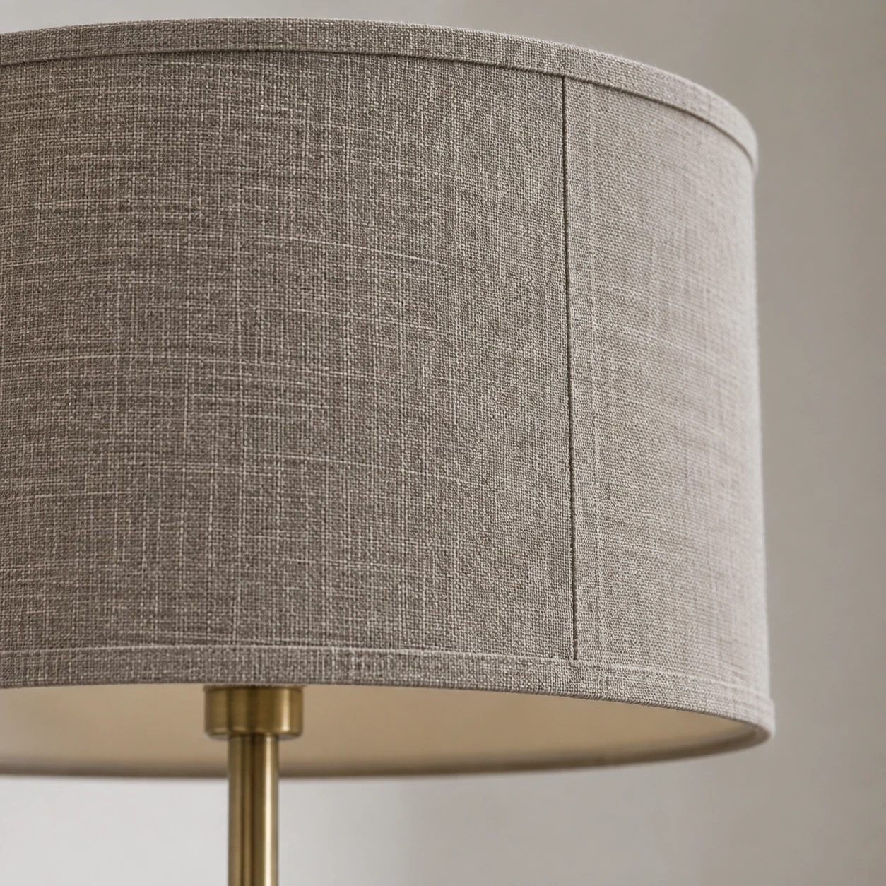 Close detail of the gray-taupe fabric shade and upper collar
