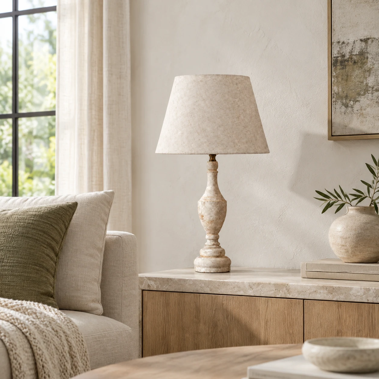 Antique white table lamp on a living room sideboard