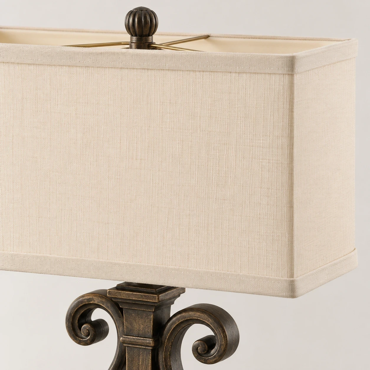 Close detail of the upper shade collar and ornate frame connection