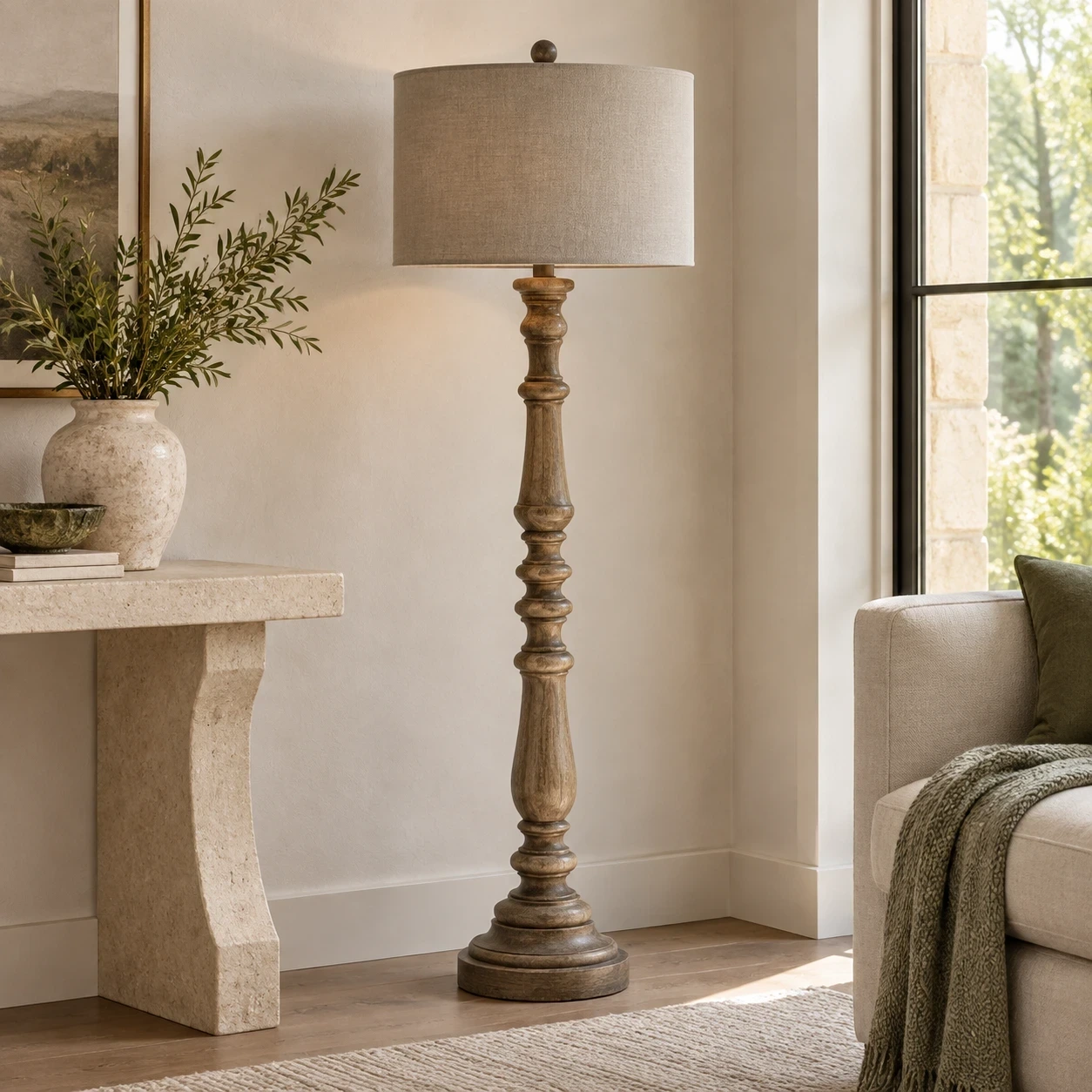 Merritt carved wood floor lamp beside a pale limestone console