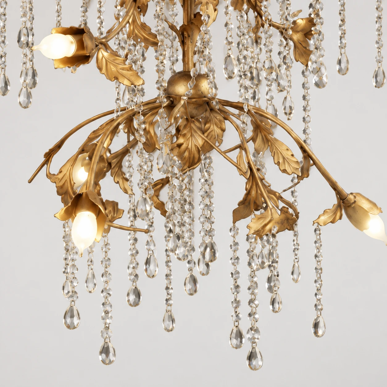 Lower tier and crystal strands detail in antique gold