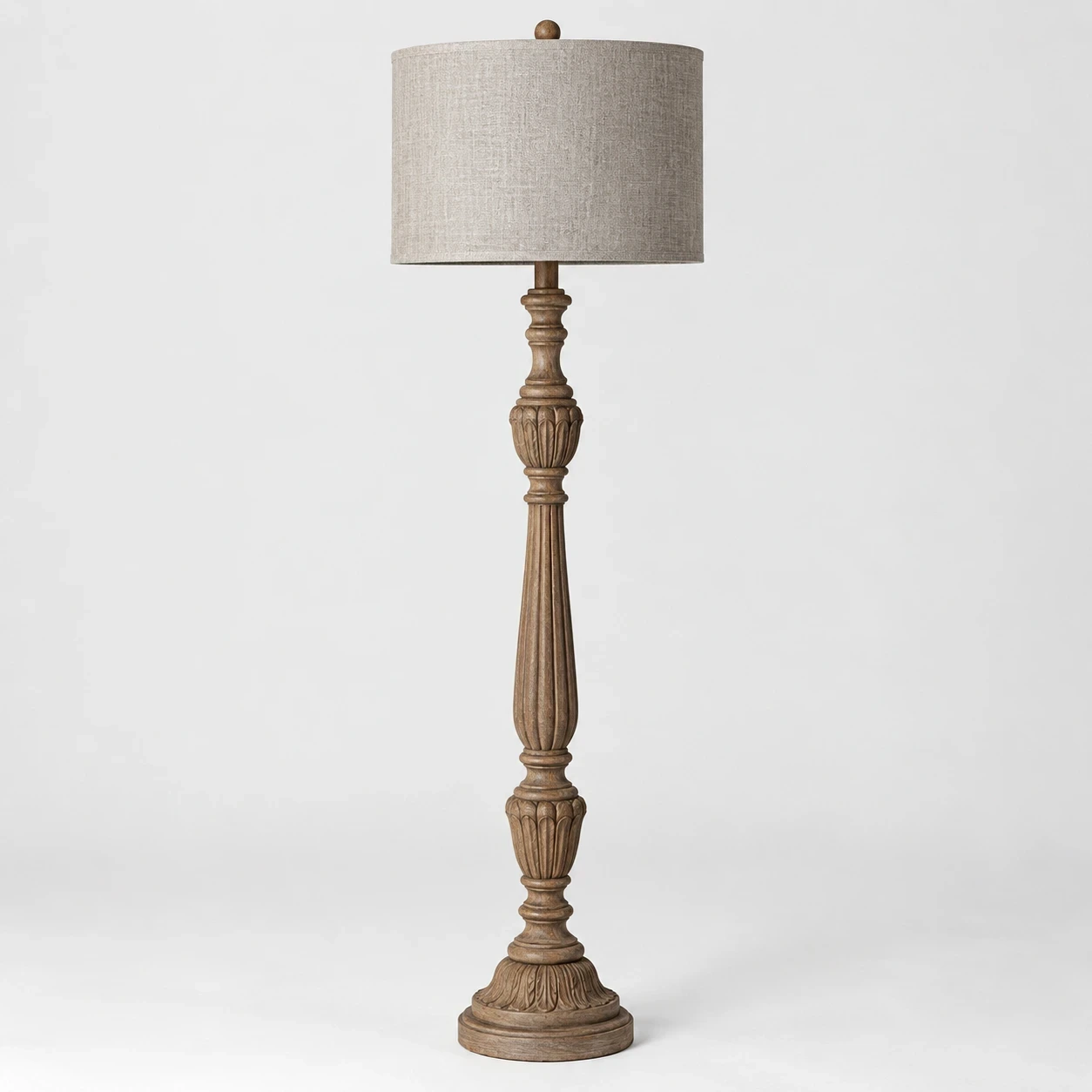 Merritt carved wood floor lamp switched off in a neutral studio