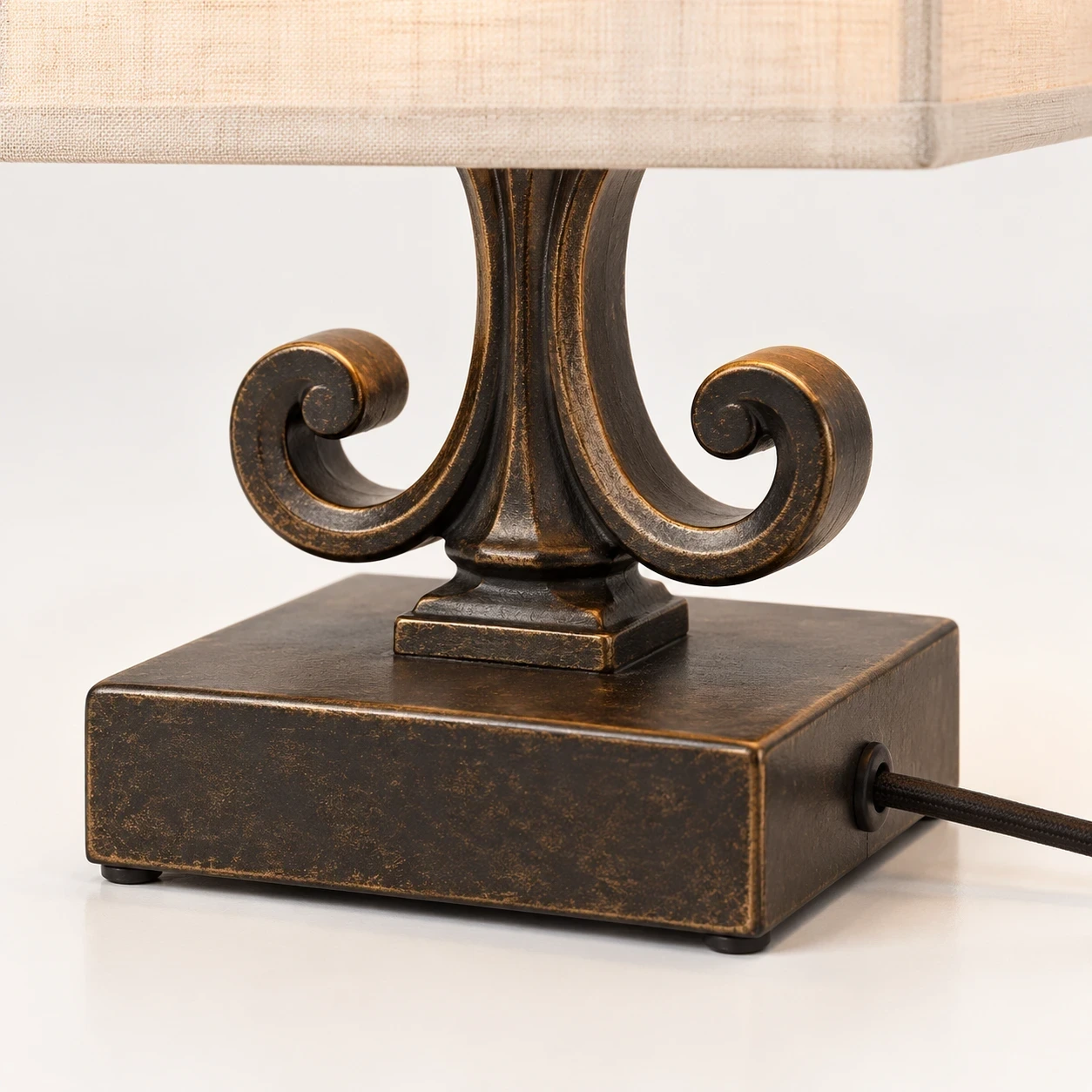 Close detail of the square dark base and visible cord exit