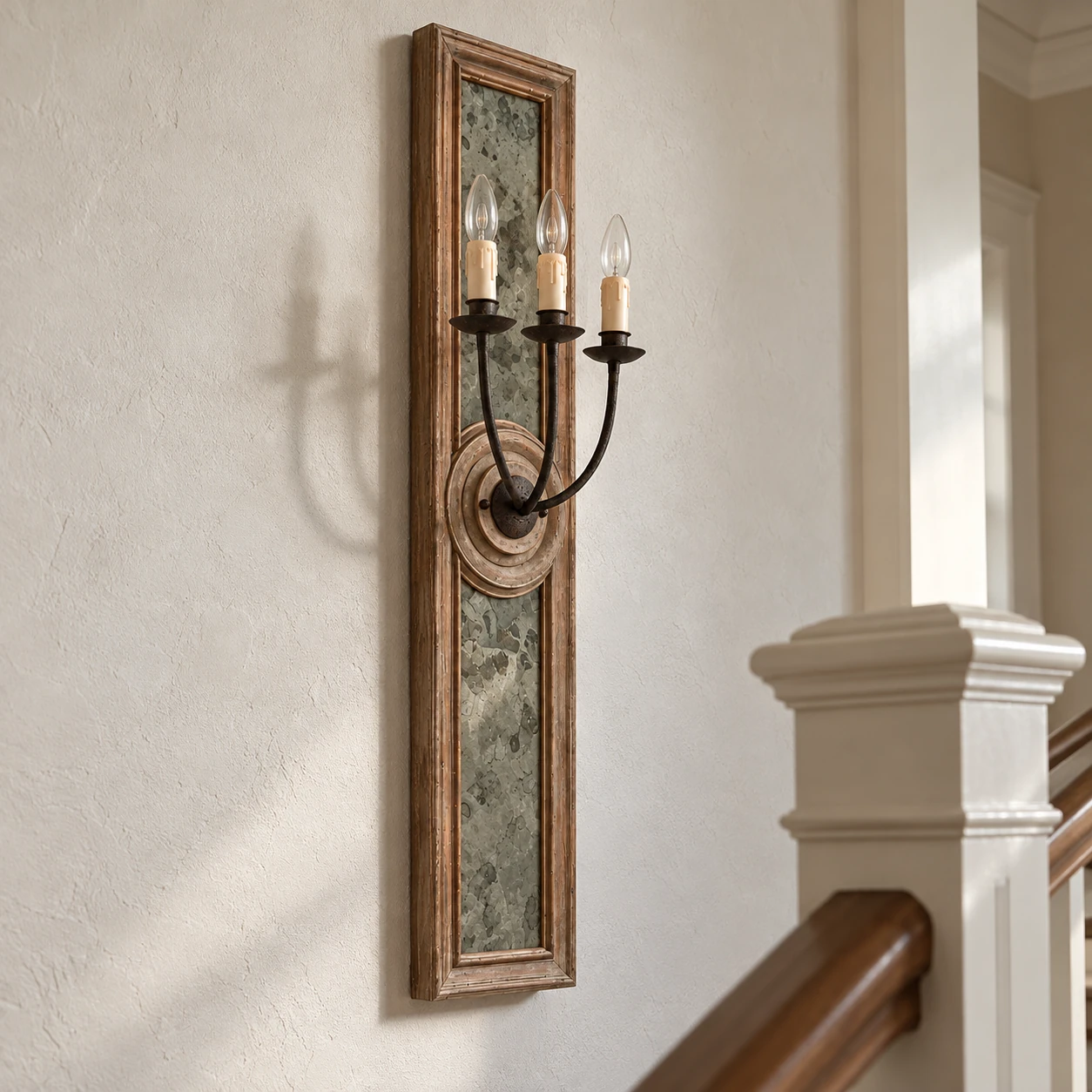 Maren carved wood wall sconce physically installed beside a stair rail