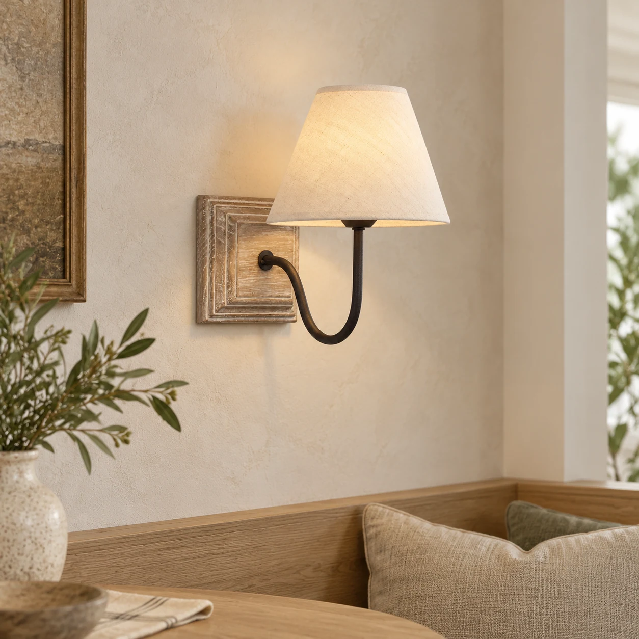 Single wood and fabric wall lamp installed at a dining alcove