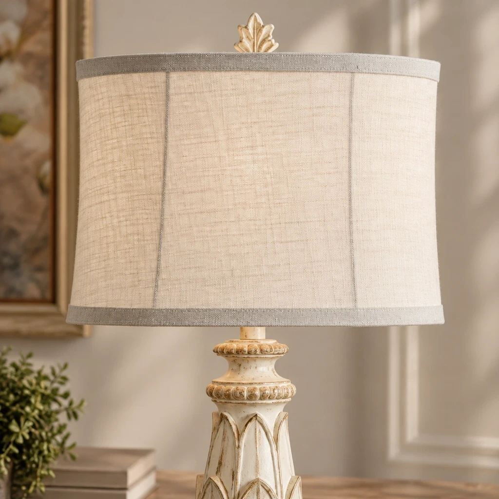 Close detail of the small finial, linen shade edge and carved floral collar