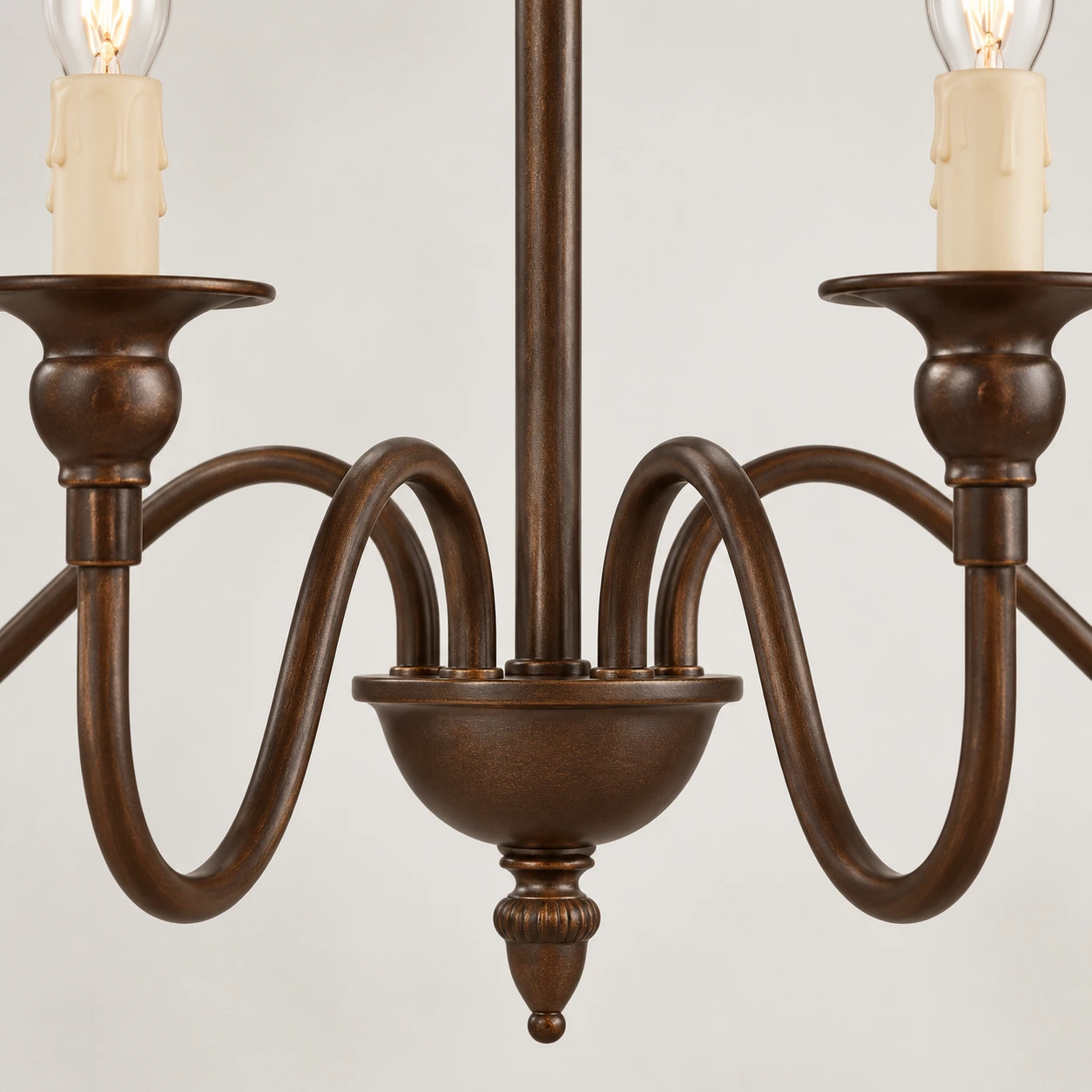Close-up of curved iron arms and lower finial