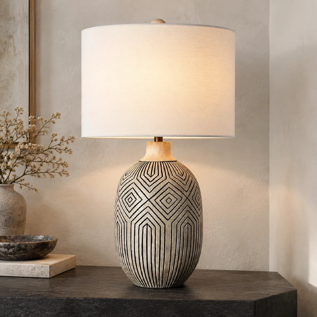 Merritt Bohemian Carved Wood Table Lamp with Fabric Shade illuminated in a pale plaster entry