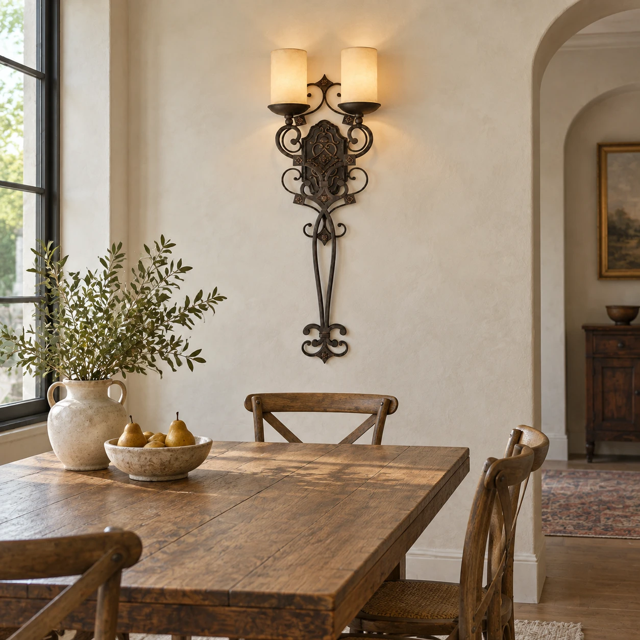 American Rustic Iron Wall Light in a compact dining room above a timber table with pale mineral plaster