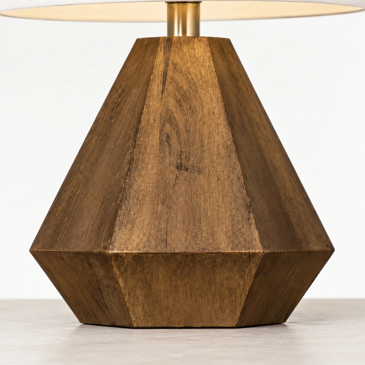 Close detail of the faceted wood lamp base