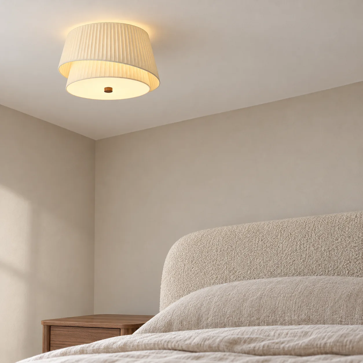 40 cm layered pleated fabric ceiling light beside a rounded walnut headboard
