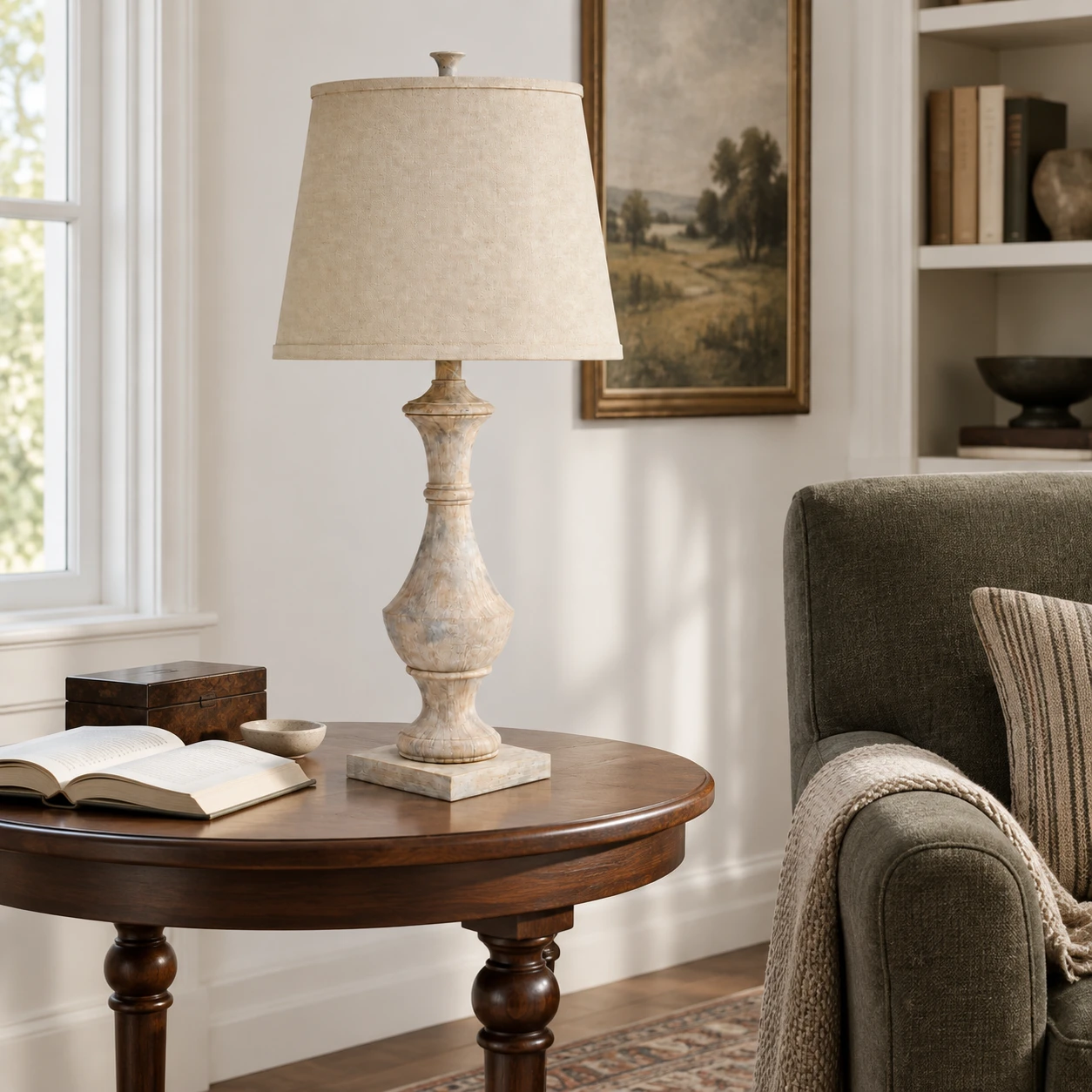 Carved wood table lamp beside a reading chair in a study