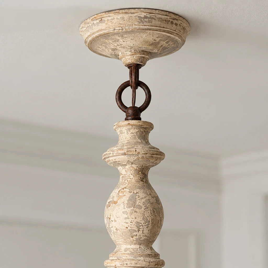 Close detail of the ceiling canopy, short hanging loop and carved leaf crown connection
