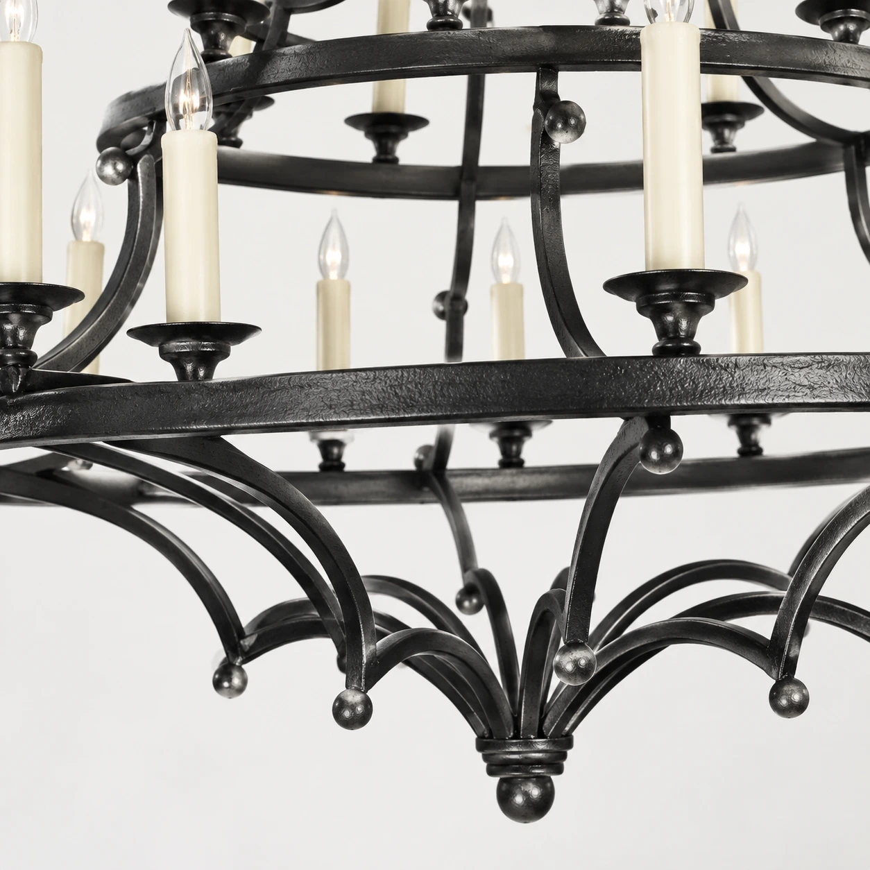 Close detail of the matte-black iron tier and lower scroll