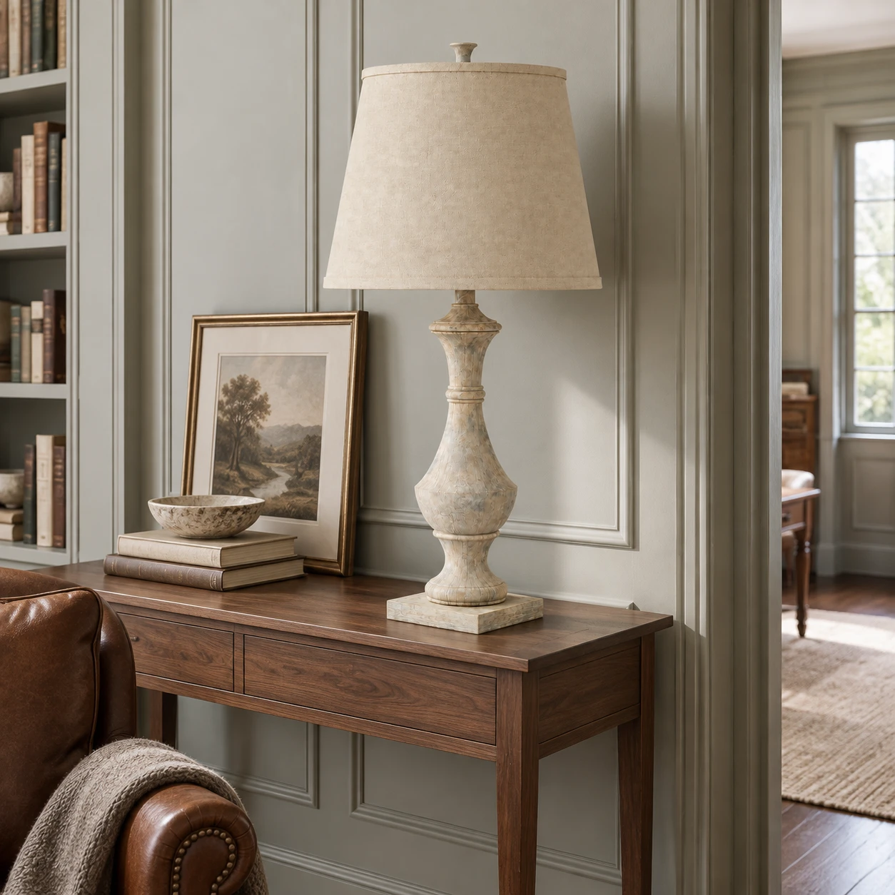 Carved wood table lamp on a home library console