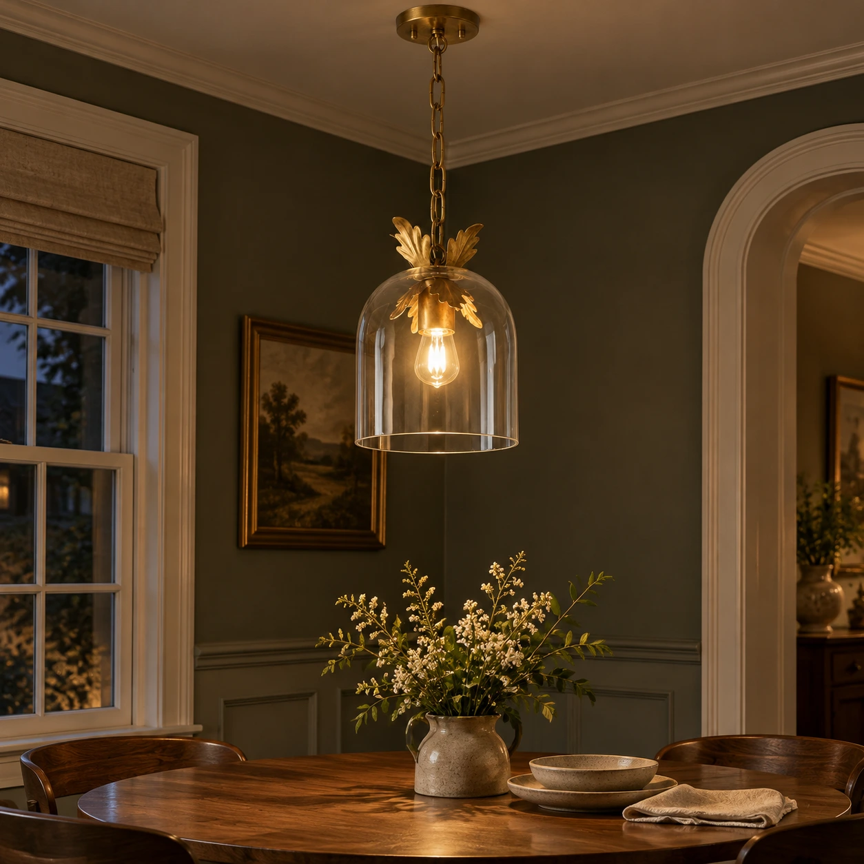 Glass pendant glowing above a dining setting