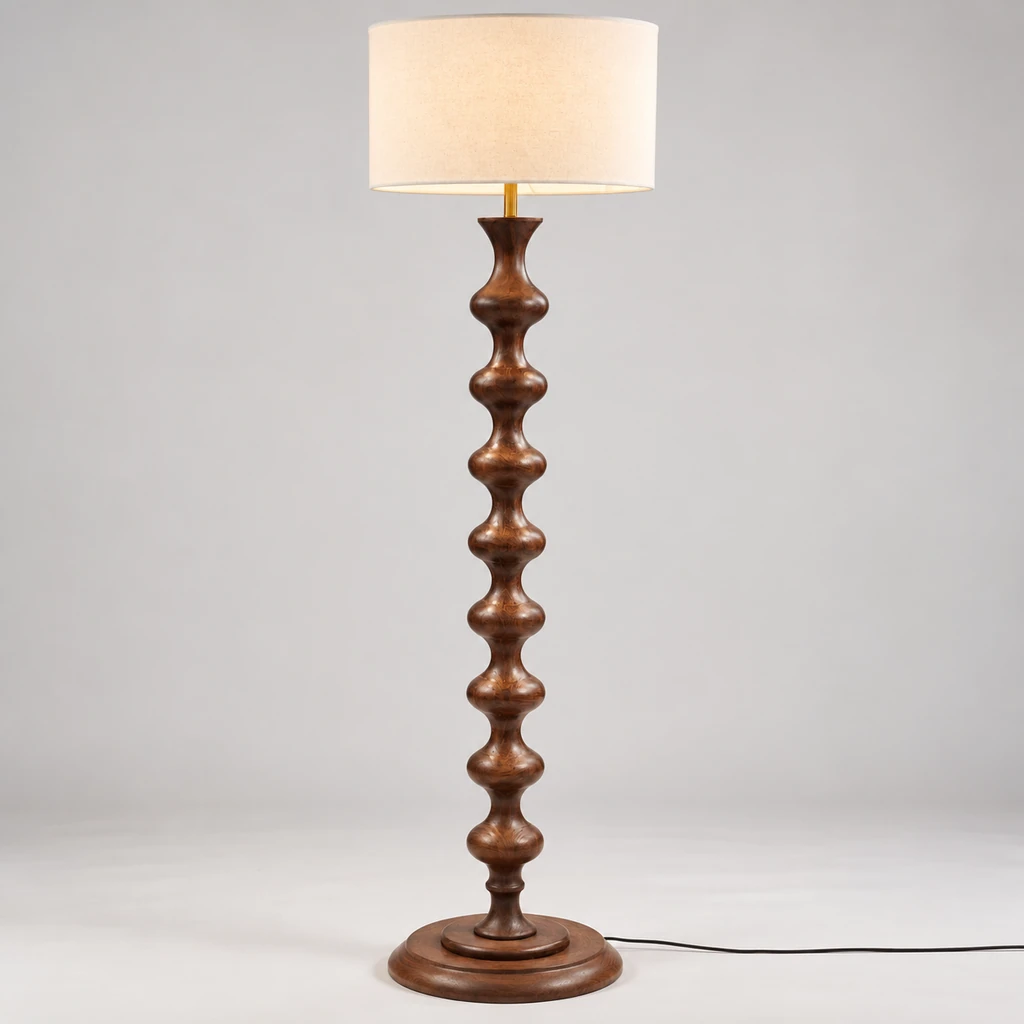 Avery sculpted walnut wood floor lamp illuminated in a neutral studio