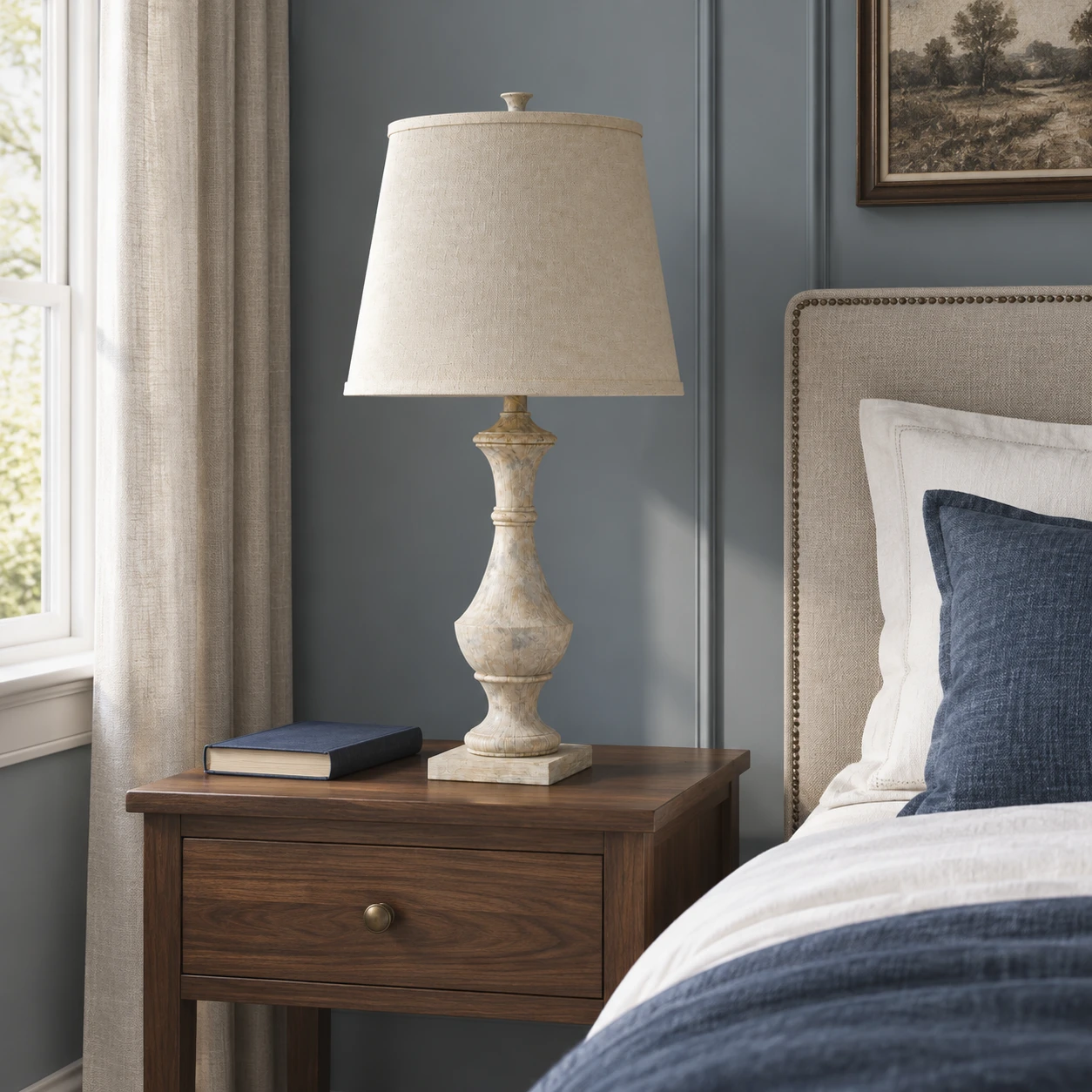 Carved wood table lamp on a bedroom nightstand